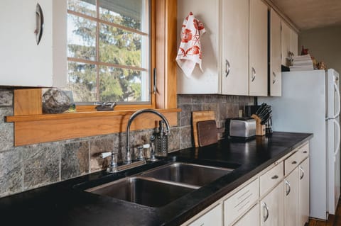 Wash dishes while looking out at the back 120 acres of farmland.