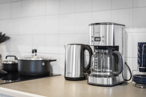 Sunbeam kettle and coffee maker, and kitchen cooking utensils.