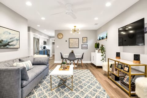 Step into comfort with our chic, open-concept living room, designed for relaxation and entertainment. Unwind on the plush West Elm couch, enjoy the latest shows on the 55-inch smart TV, and indulge in musical nostalgia with our classic record player and S