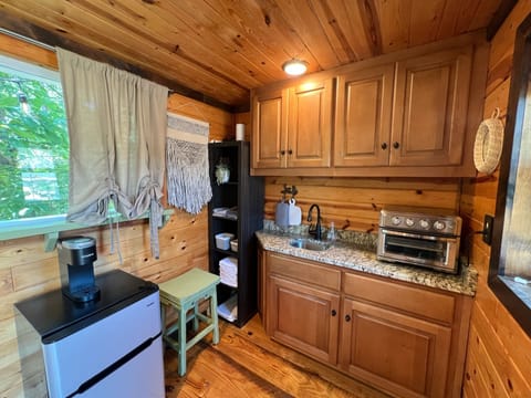 A mini-fridge with freezer, space for a pint of ice cream for your your midnight snack!