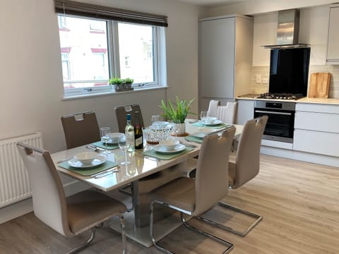 Enjoy cooking and dining in the modern kitchen diner at 4 Bayhouse, perfect for your holiday stay in Shanklin, Isle of Wight.