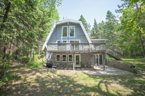 Back side of the cabin with deck and patio.