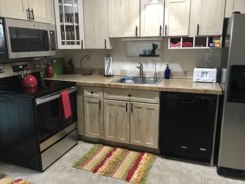 The kitchen has full-sized appliances, & the cabinets are generously equipped. 