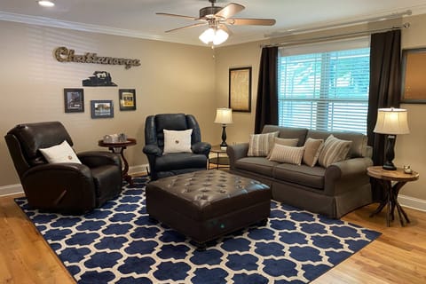 Spacious living area open to kitchen and access to front porch. Includes two recliners and a full size foldout bed in the couch.