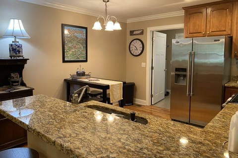Dining table seats 4, with additional 4 stools at the kitchen island