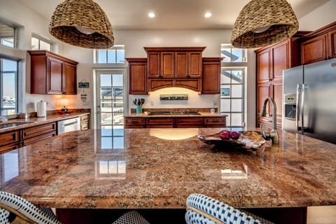 Full kitchen and bar seating overlooking the bay