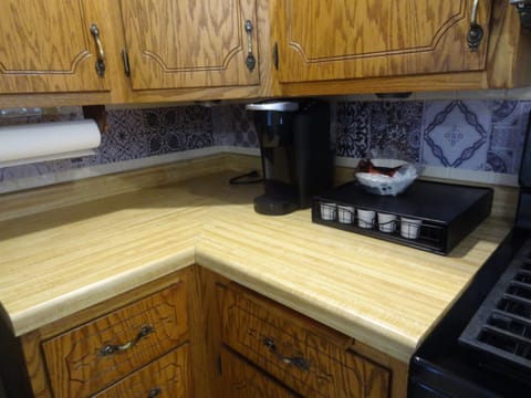 Kitchen with dining table, dishwasher, stove, fridge, microwave, Keurig and regular coffee pot, lots of cupboard space, dishes, pots, pans, silverware.