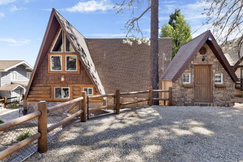 Welcoming cabin entry surrounded by towering pine trees, offering fresh mountain air and a peaceful forest setting—the perfect first impression for your Big Bear Lake getaway.