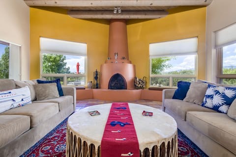 Large, comfortable living room with built-in kiva fireplace and long views. 