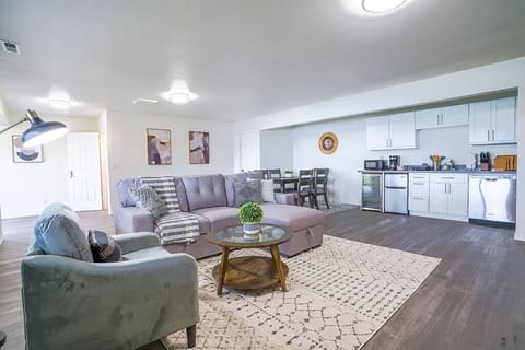 The second open living area has a kitchenette, dining set and a comfy couch & chair 