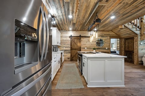 "Culinary dreams come to life in our spacious kitchen — the heartbeat of our cabin."