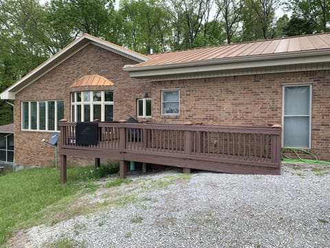Left side of house with deck to back door