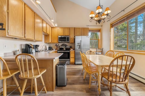 Full size kitchen featuring stainless steel appliances and hardwood flooring.