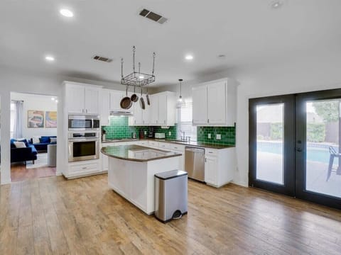 This spacious kitchen features granite countertops, a large kitchen island, and updated stainless steel appliances. Be ready to unleash your culinary prowess!