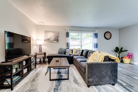 Livingroom with large Smart TV & sectional couch.  Yoga mat and exercise bands.