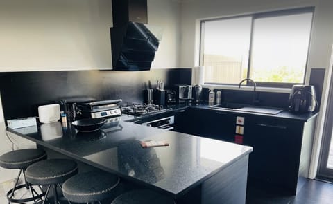 kitchen with grill, coffee machine, toaster, kettle, air fryer and lot of other