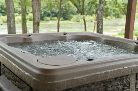 Relax in the private hot tub surrounded by peaceful nature
