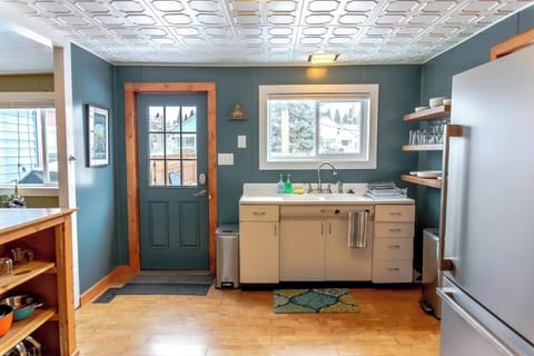 Bright kitchen with antique sink and disposal.  
