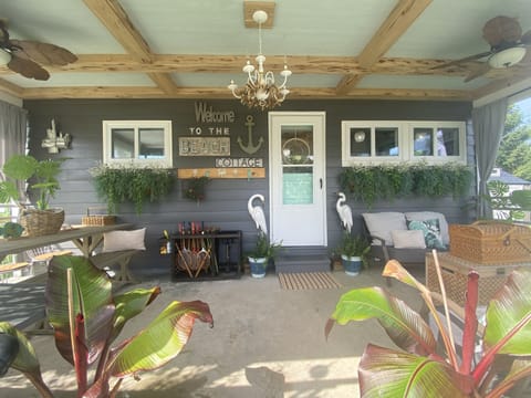 Private Covered Porch has 2 ceiling fans, table for 6  and soft seating. 