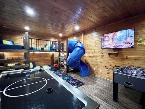 Basement Gameroom/Bunk room with 4 twin beds, air hockey, foosball, and arcades