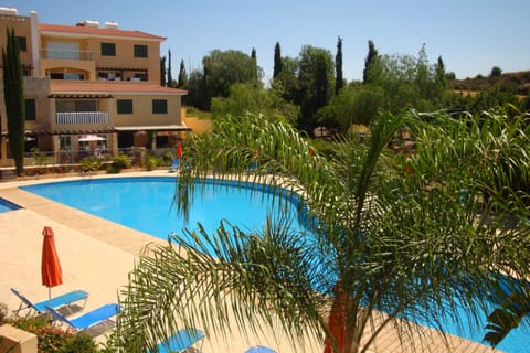 Lovely pool with sun beds and parasols for your use