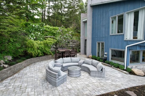 upper patio with a dinning area & sitting area. A waterfall behind for ambiance.