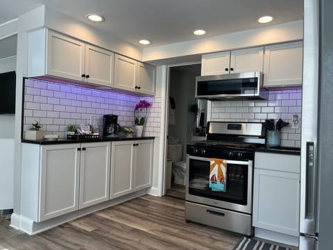 Under-cabinet lights add to kitchen functionality and elegance.