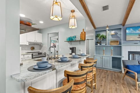 The breakfast bar, comfortably seating four, provides easy access to the living room and a great spot for dining or conversation.