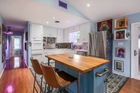 Custom furniture throughout house including this beautiful Teak Wood island. Dog door goes into backyard for small to med size dogs. 