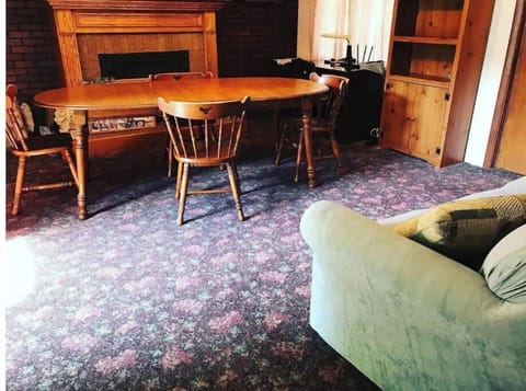 Back dining room, gas fireplace & couch. Remove cover to access pullout couch. 