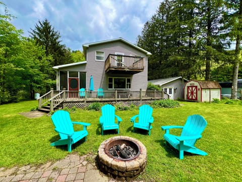 Backyard/creek side of home with fire pit