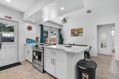 “Modern kitchen with island seating and stylish décor—perfect for cooking and gathering at your Airbnb stay.”