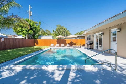 “Private pool with lounge chairs and umbrellas—ideal for sunbathing and your Airbnb getaway.”