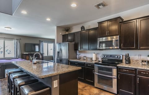 Generous Chef's kitchen with double oven, huge island and granite countertops.