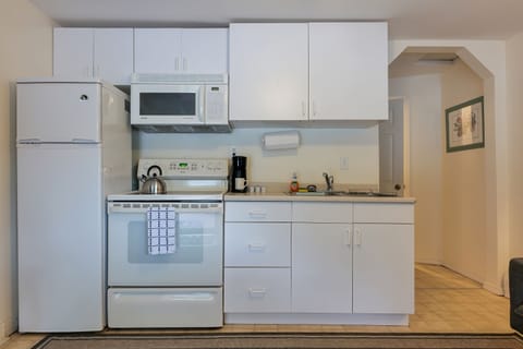 Kitchen with Full sized Refrigerator, Microwave, and Coffee Maker. 
