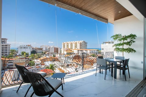 Dine alfresco on your private terrace with stunning city views stretching to the sea beyond.