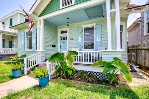 Cozy front porch with comfortable patio set overlooking neighborhood.