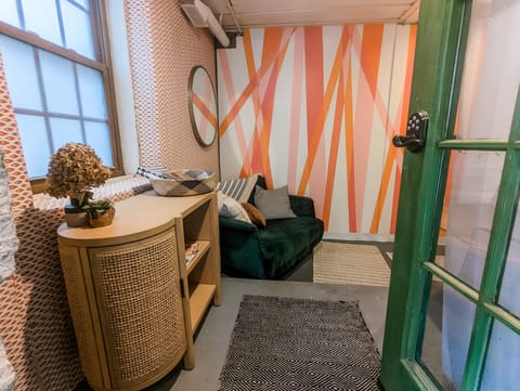 Colorful and bright entry area. Doubles as a seating area and workspace.