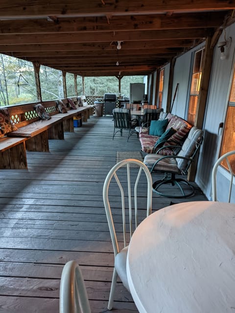 Spacious covered back porch with grill and tables and chairs. Come and enjoy.