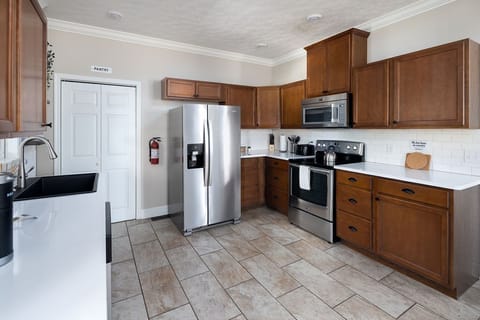 Another angle showcasing kitchen layout & easy access to backyard door