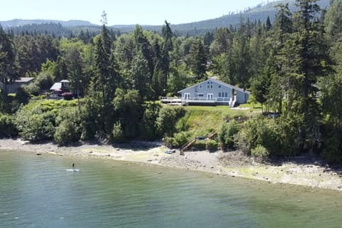 This magical house on Sequim Bay has 160' of private waterfront & tideland