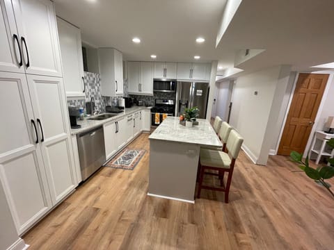 Fully stocked kitchen with full-size stainless steel appliances, and cookware.