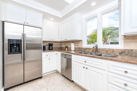 The kitchen looks out onto the quiet neighborhood street.
                