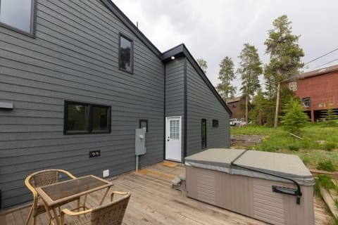 Spacious back deck with outdoor seating and access to the private hot tub.