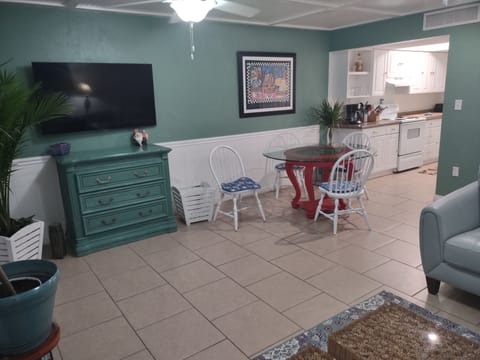 55 inch smart TV. leather sofa and love seat, all colorfully accented.