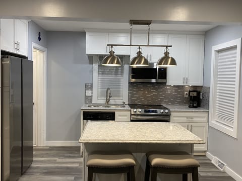 Kitchen with stone countertops and stainless steel appliances.