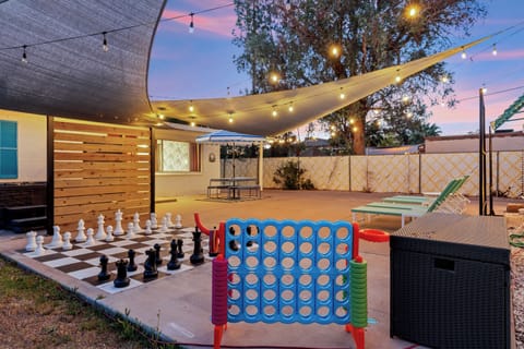 Enjoy this spacious and entertaining outdoor patio complete with a hot tub, life-size chess board, connect 4, loungers and picnic table.  All shaded and lit up at night!