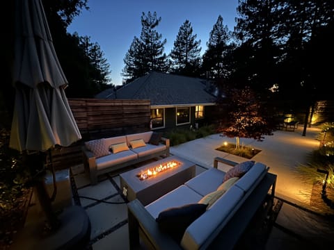 Front patio with fire pit and 8 person dining area. 