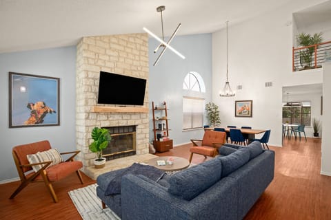 Main living area with smart TV, fireplace, and vaulted ceiling