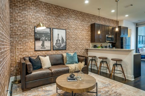 Open concept living area with designer furnishings and smart TV.